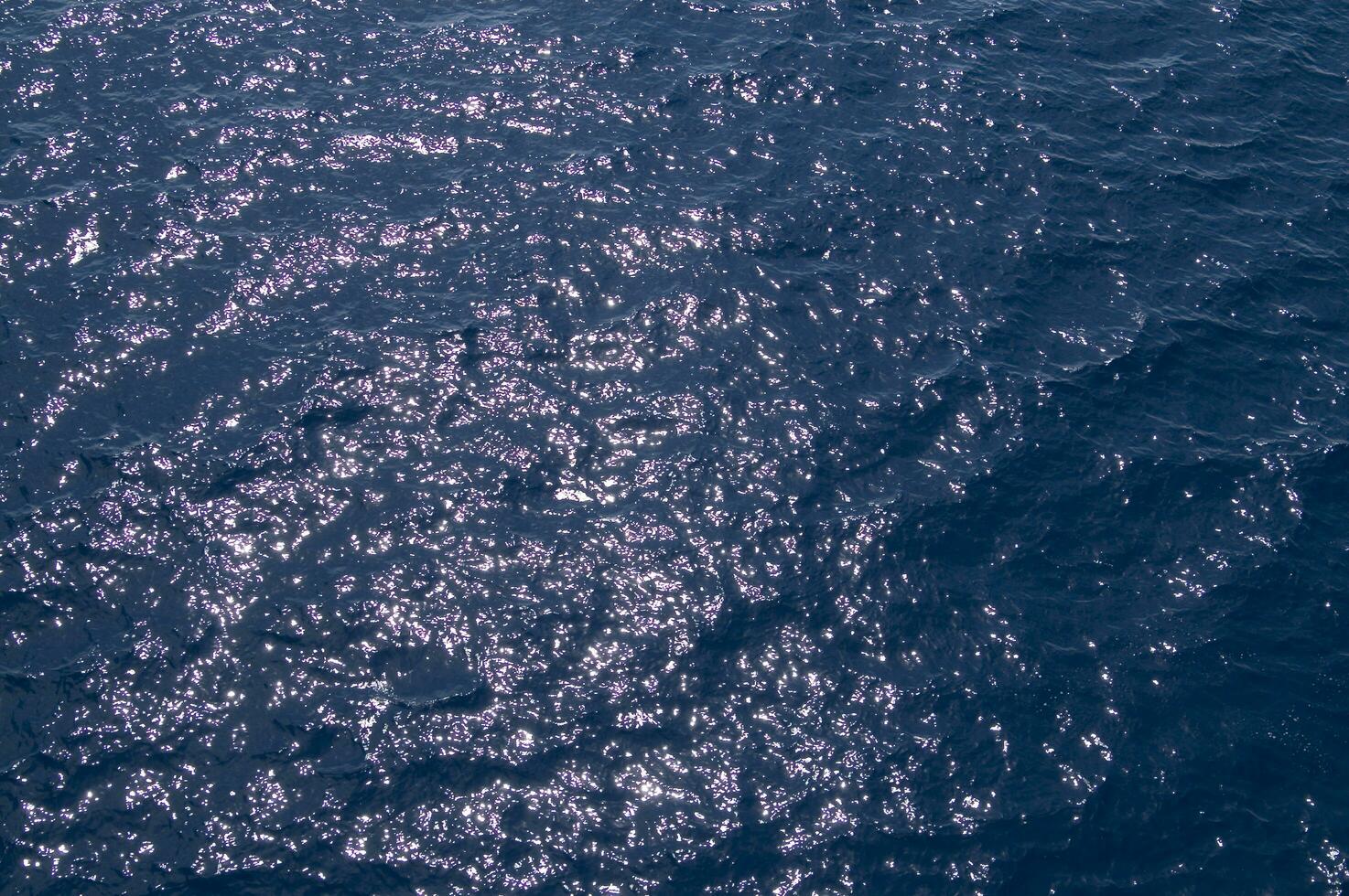 an aerial view of the ocean with a boat in the water photo