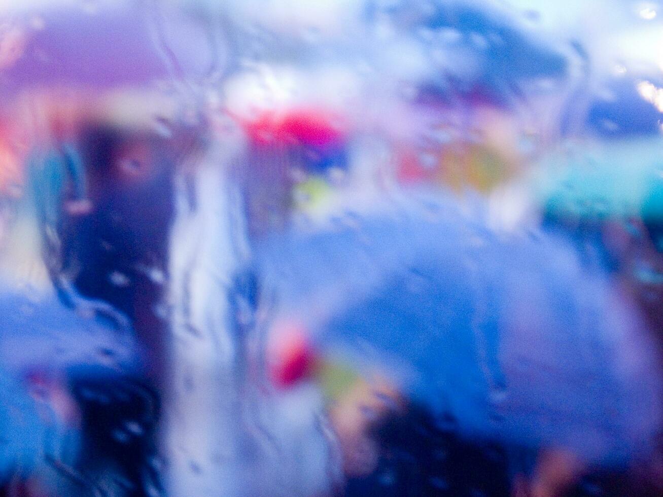 a blurry image of a person holding an umbrella photo