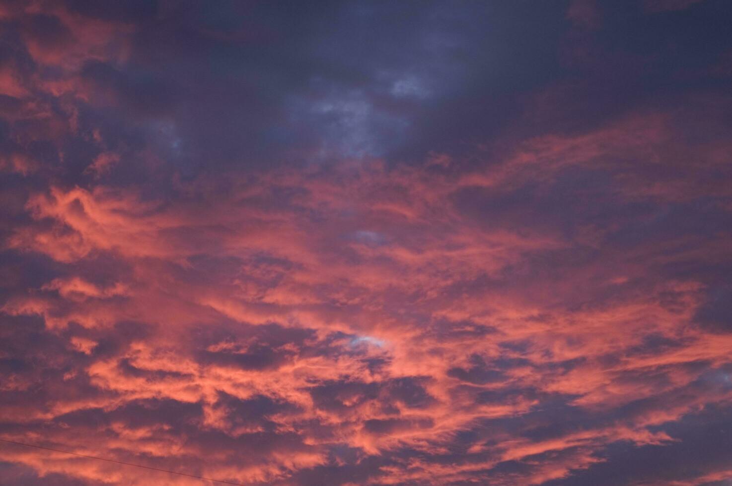 a red and orange sky with clouds photo