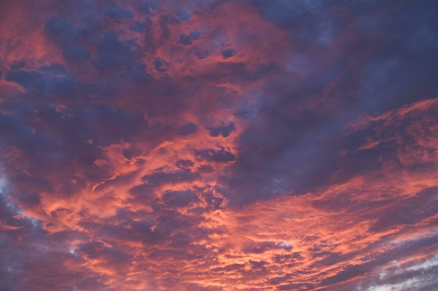 a red and orange sky with clouds photo