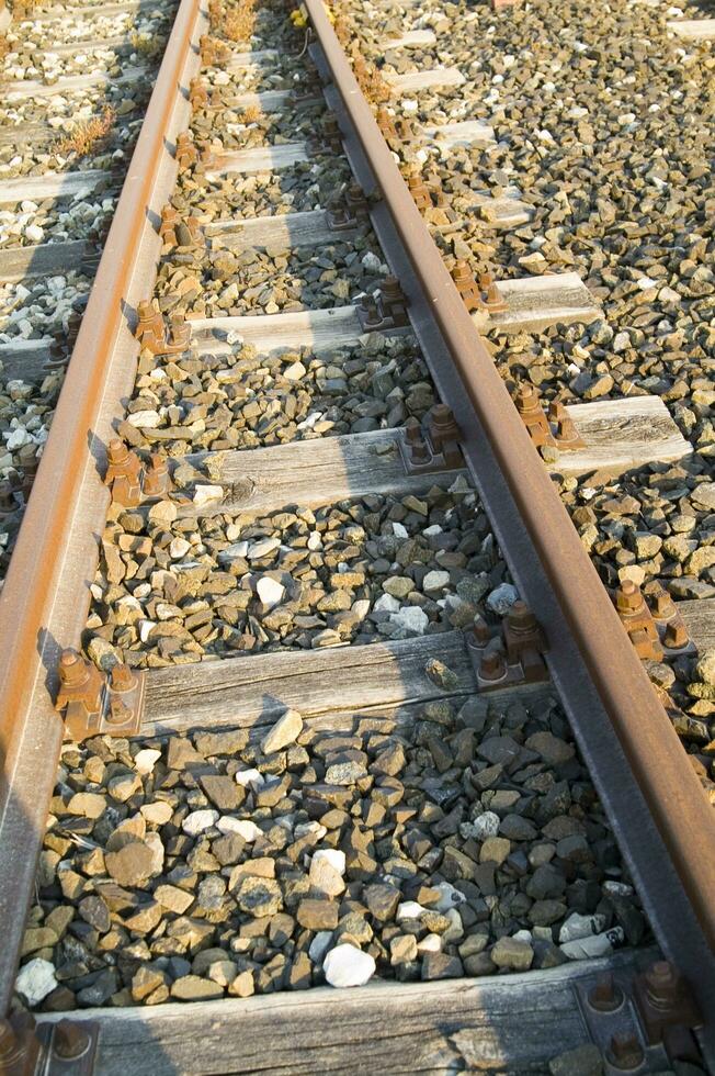 a close up of a railroad track with gravel photo