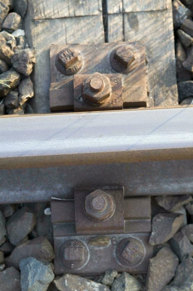 a close up of a railroad track with gravel photo