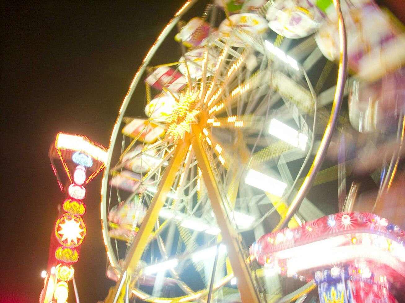 view of a funfair at night photo