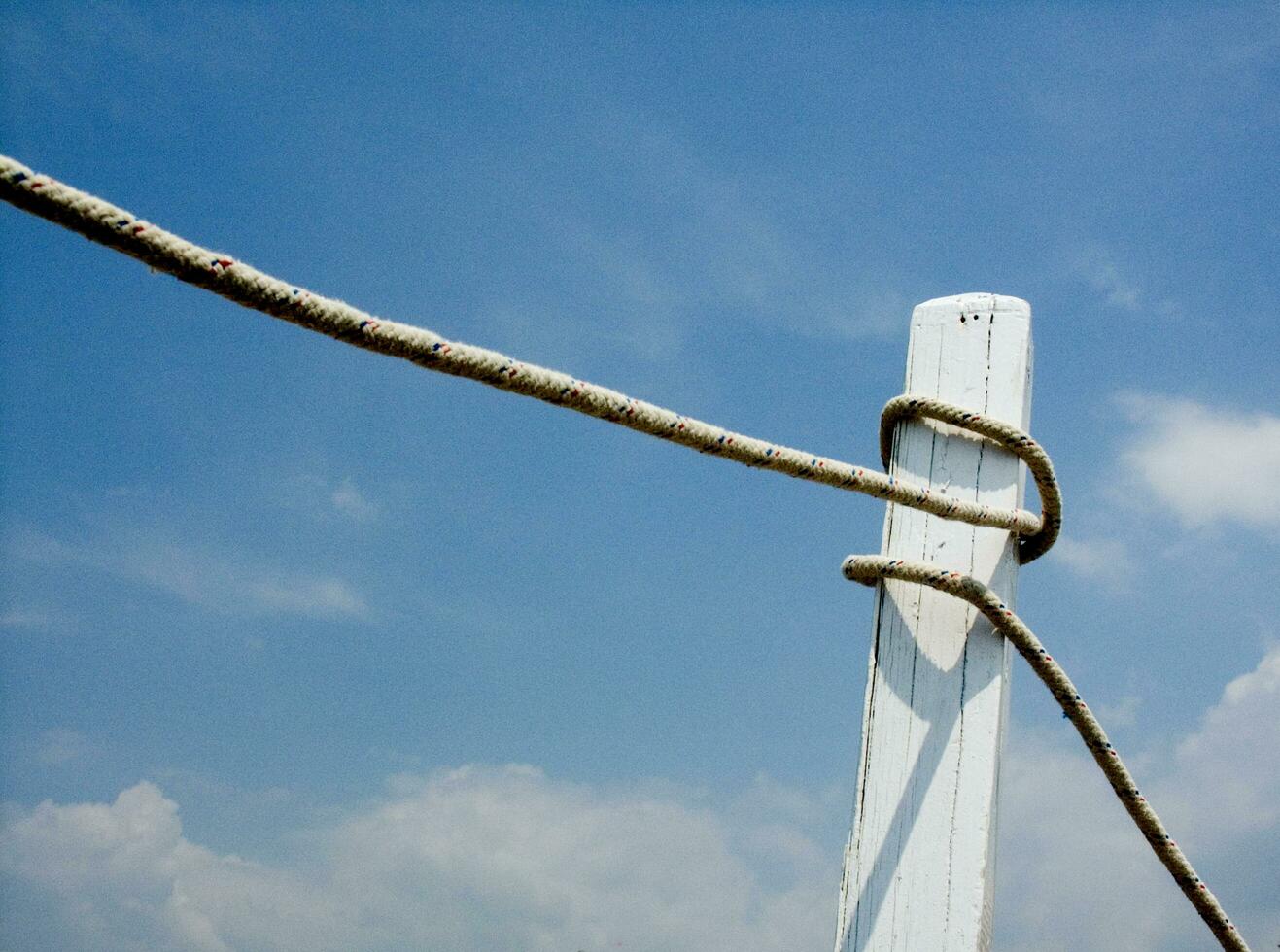 a white post with a rope tied to it photo