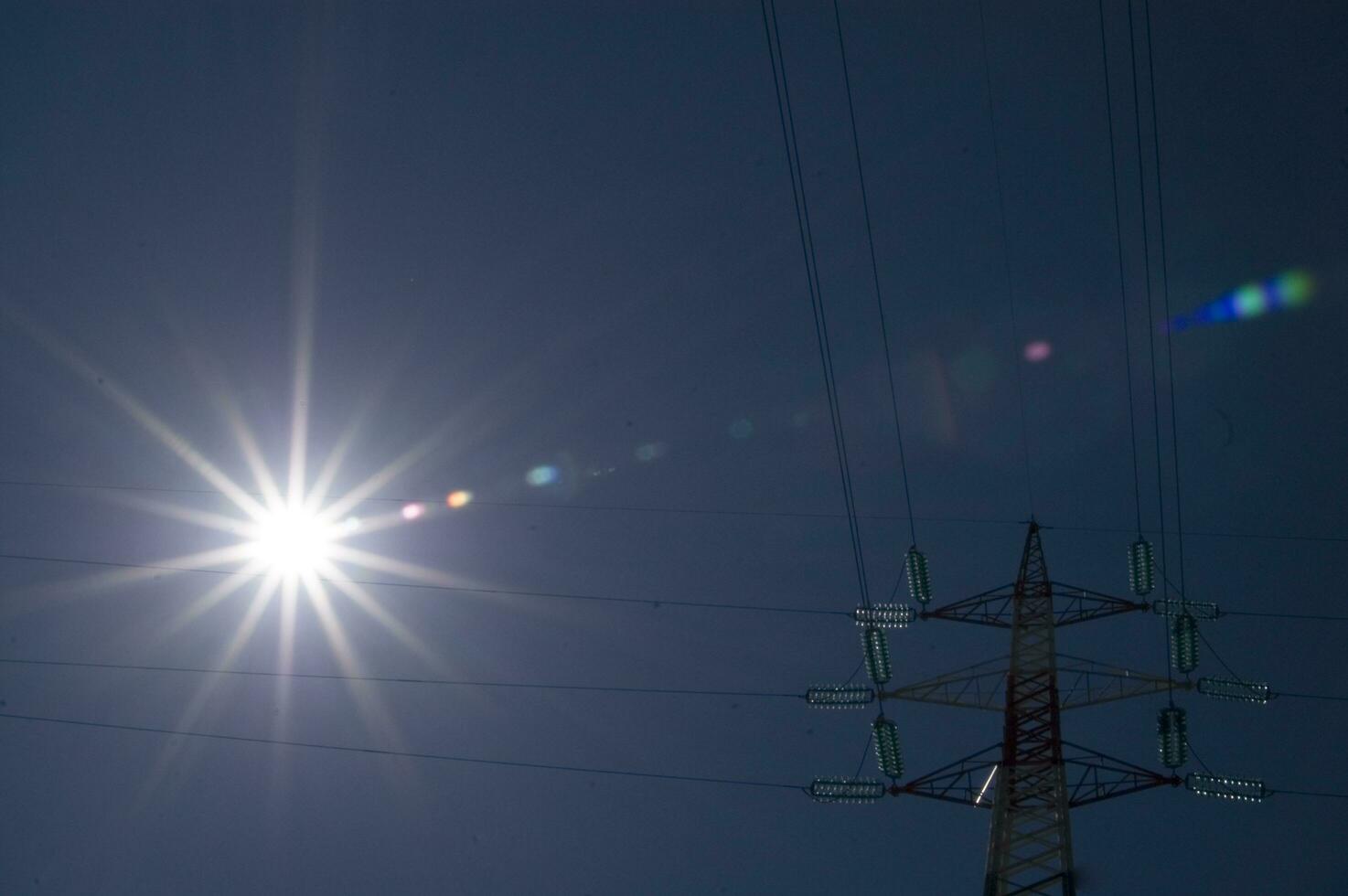 a high voltage power line with wires and poles photo