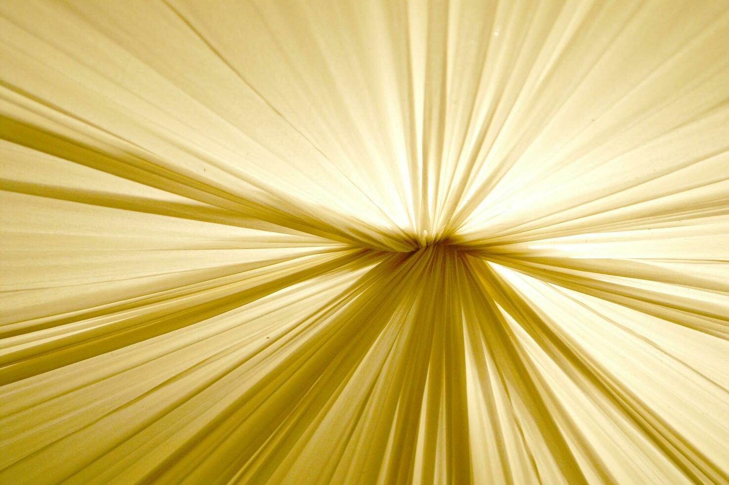 golden light rays on a fabric background photo