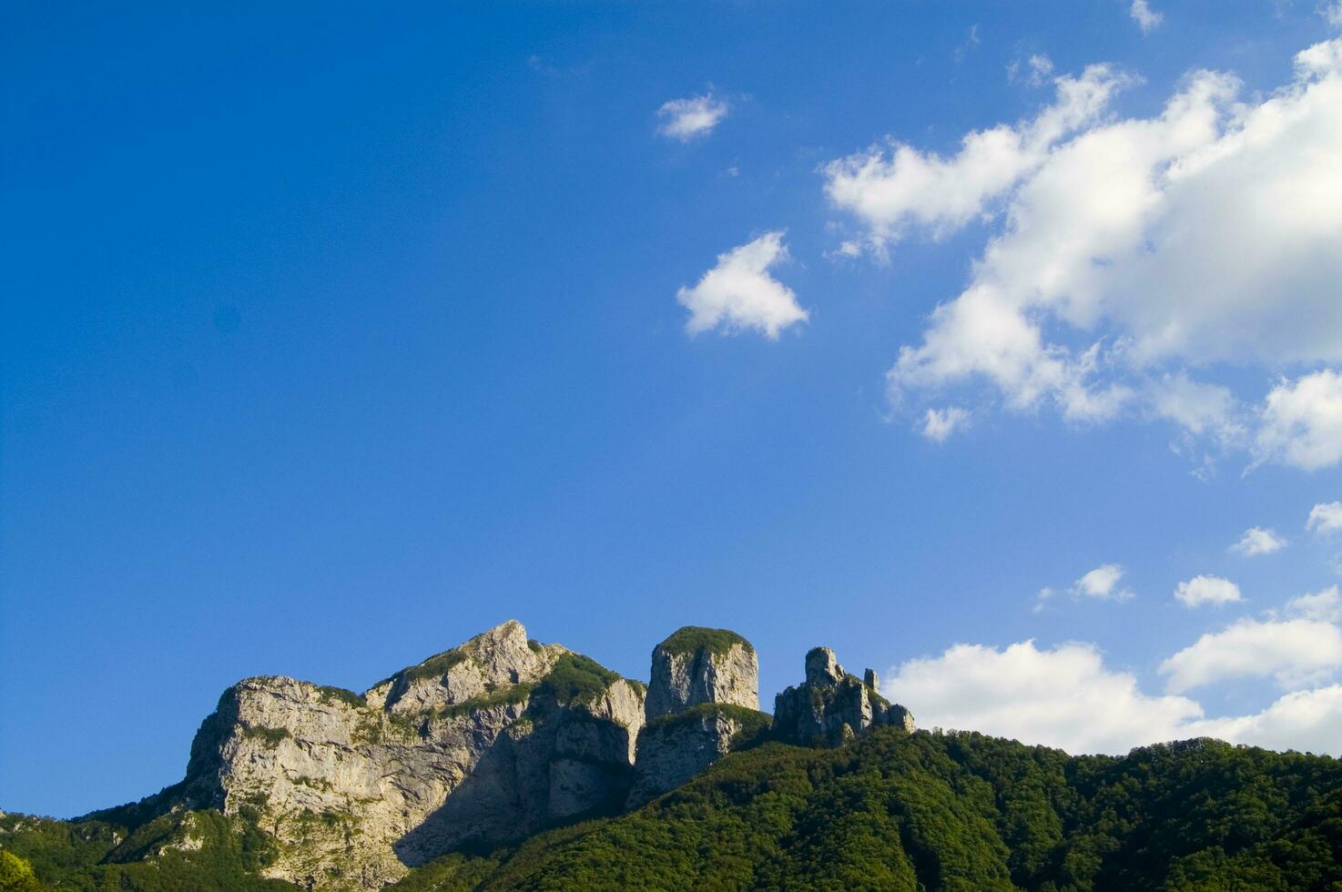 a mountain range with a few houses on top photo