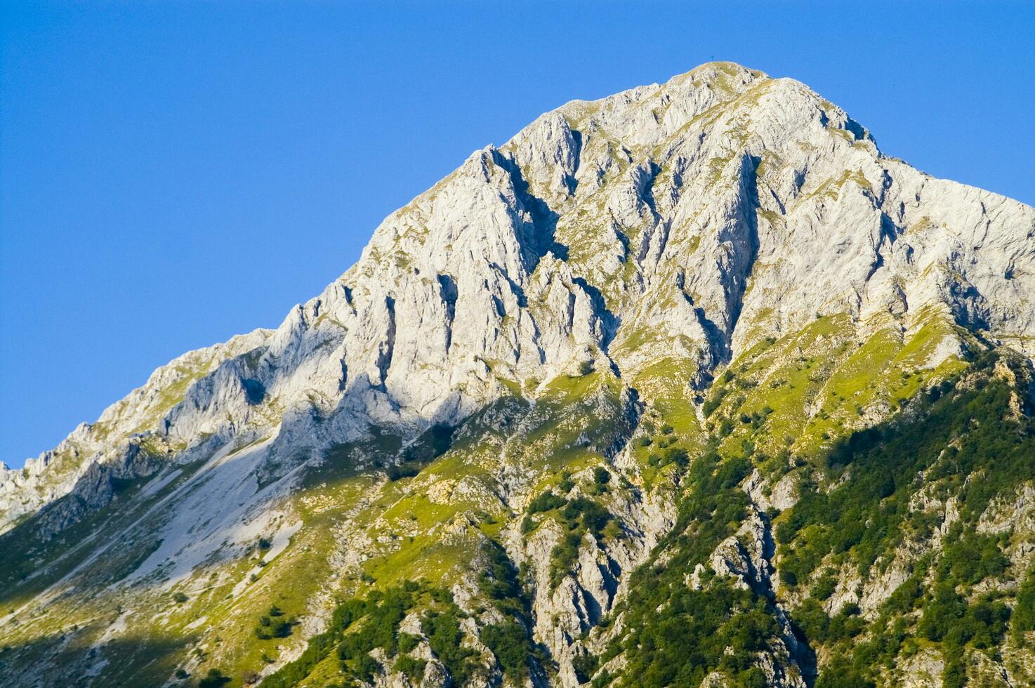 a mountain range with a few houses on top photo