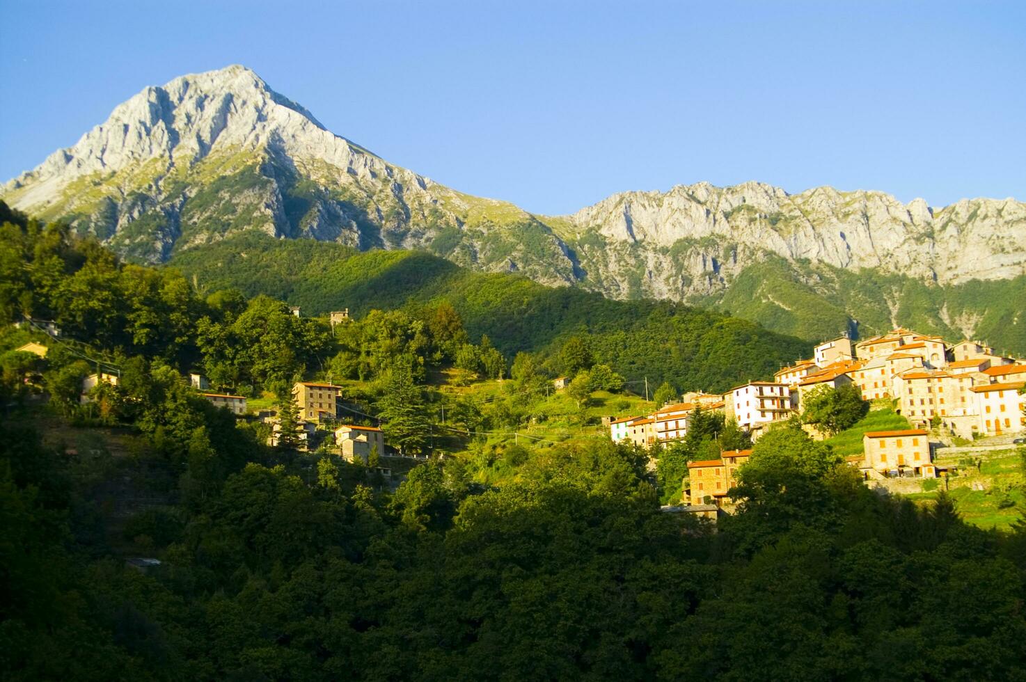 a mountain range with a few houses on top photo