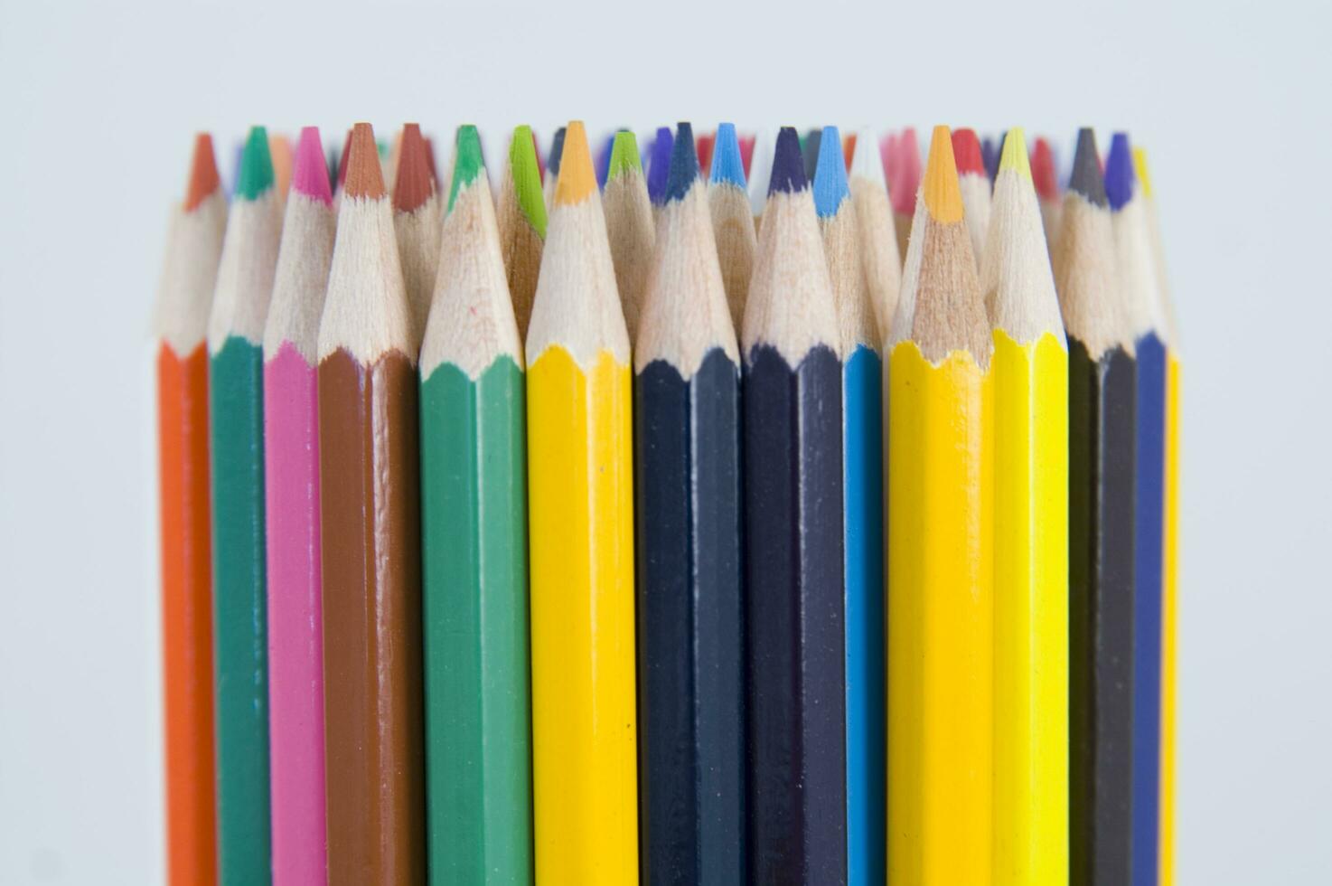 many colored pencils are arranged in a row 27097429 Stock Photo at Vecteezy
