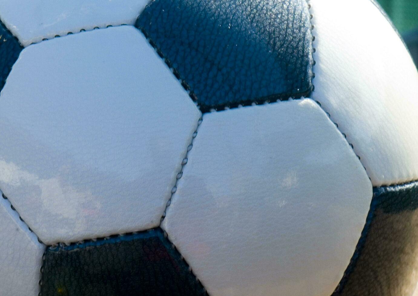 a close up of a soccer ball with leather photo