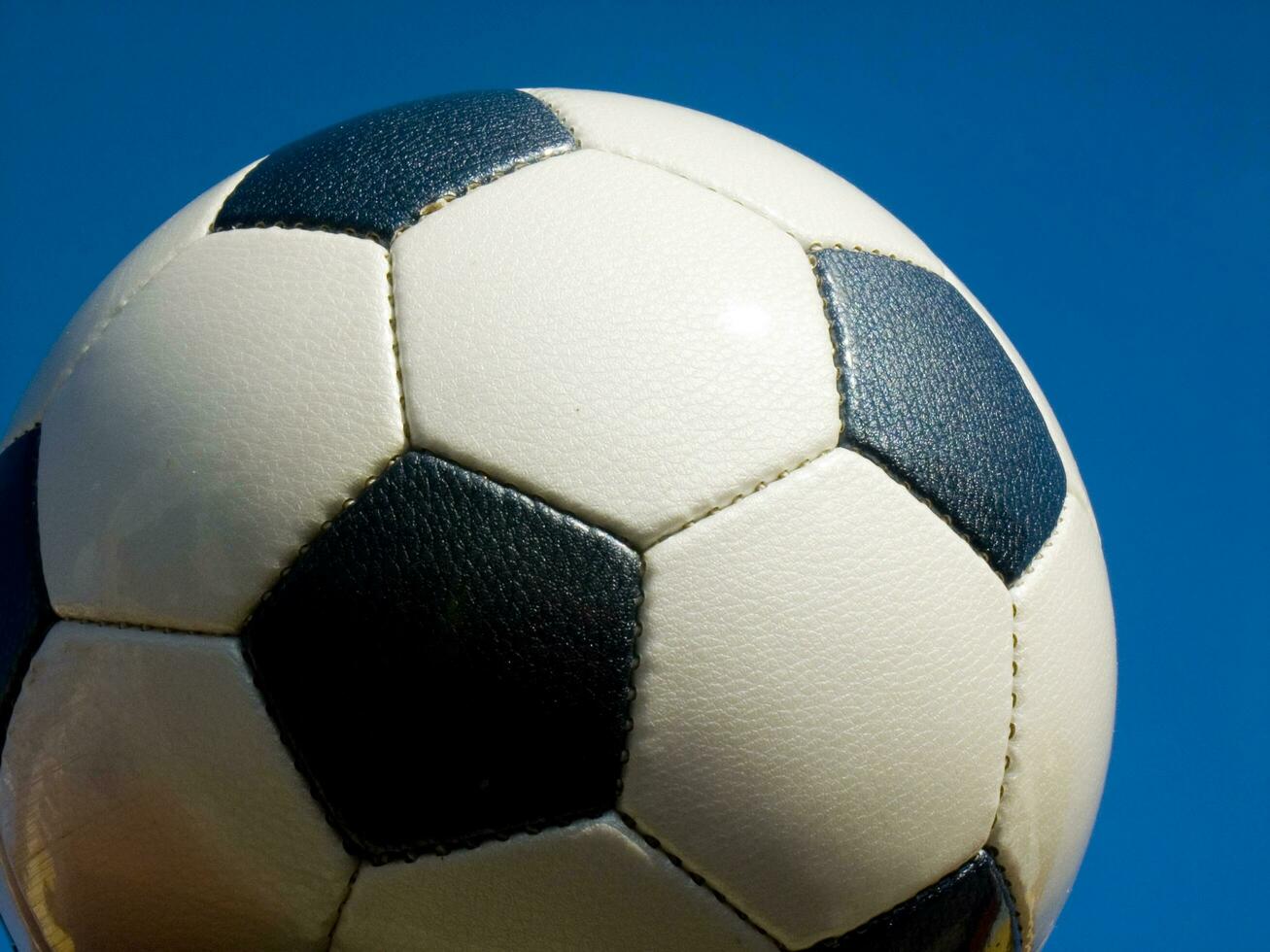 a close up of a soccer ball with leather photo