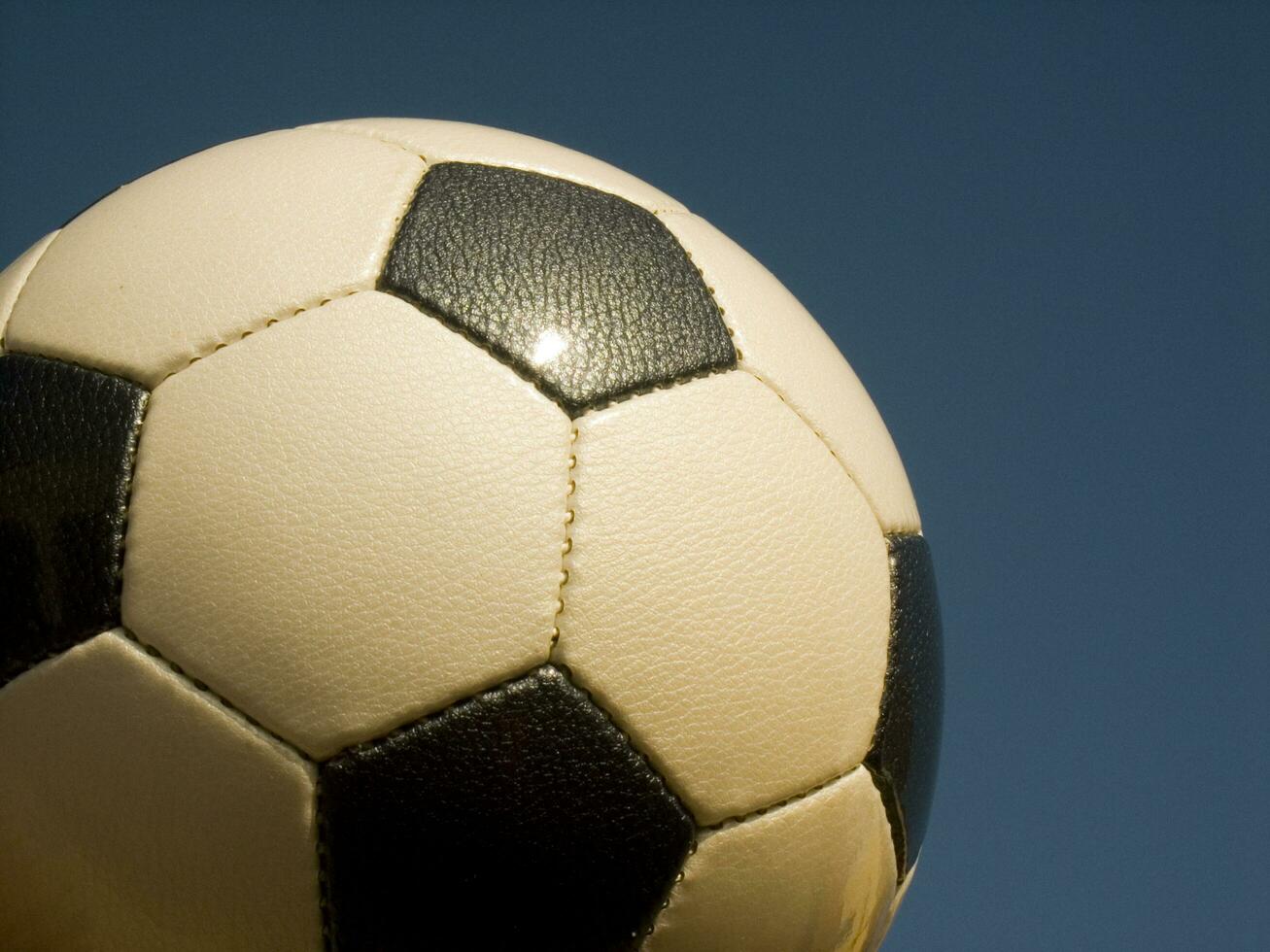 a close up of a soccer ball with leather photo