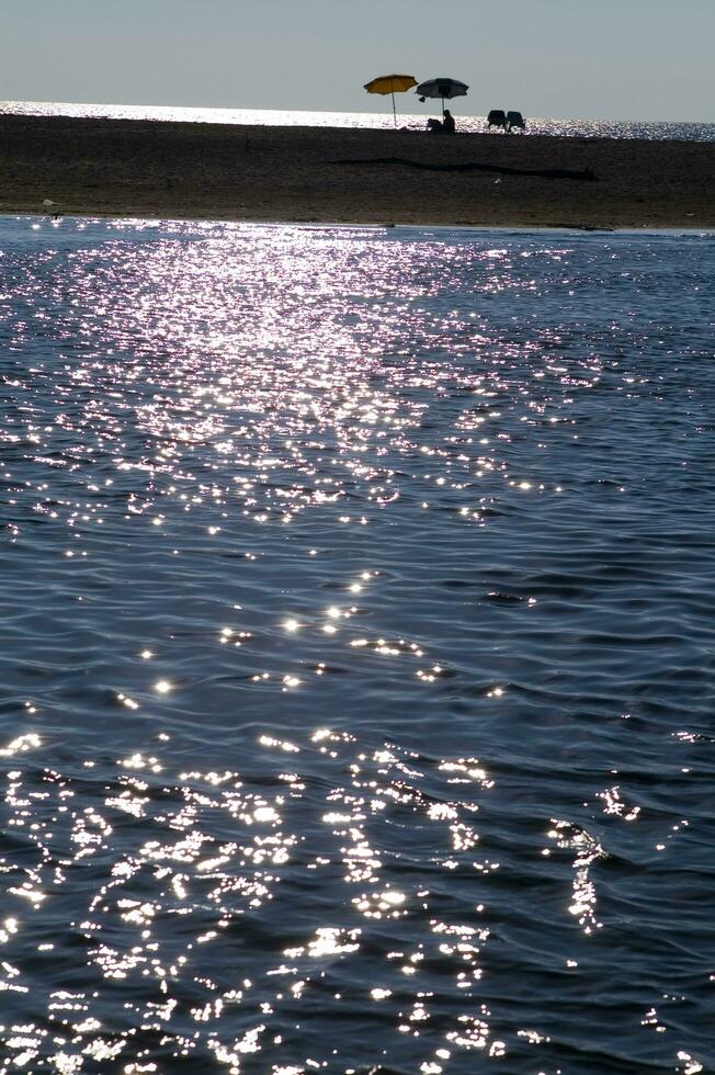 a boat is in the water at sunset photo