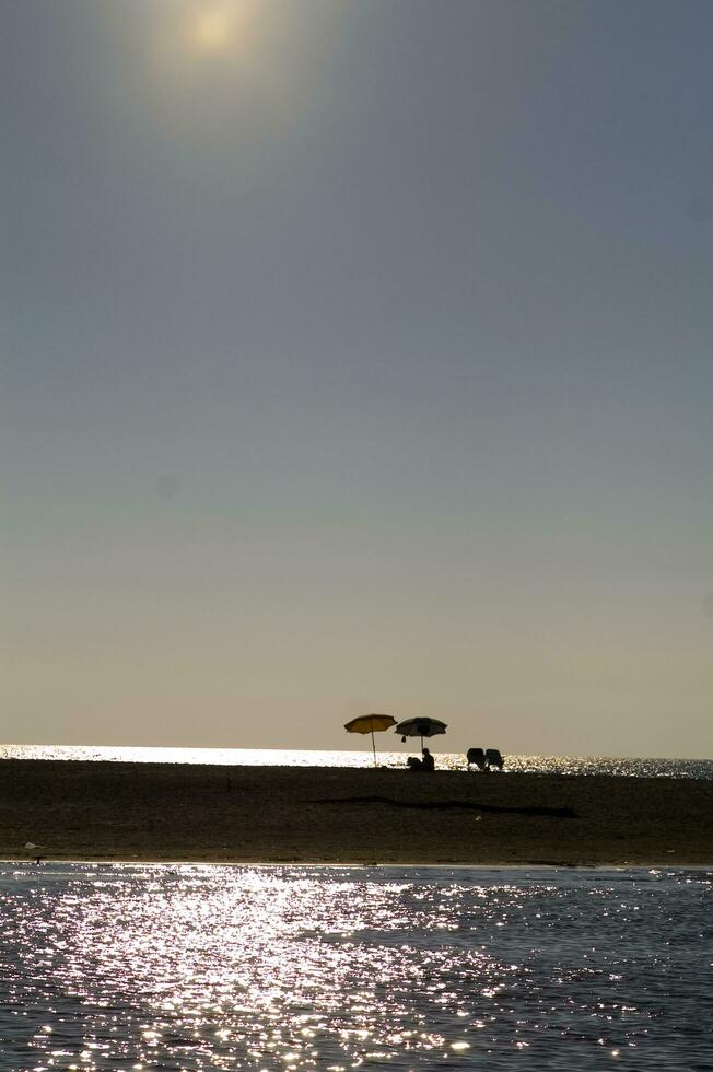 a boat is in the water at sunset photo