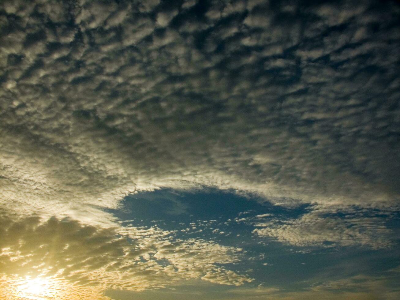 a view of the sky with clouds and sun photo