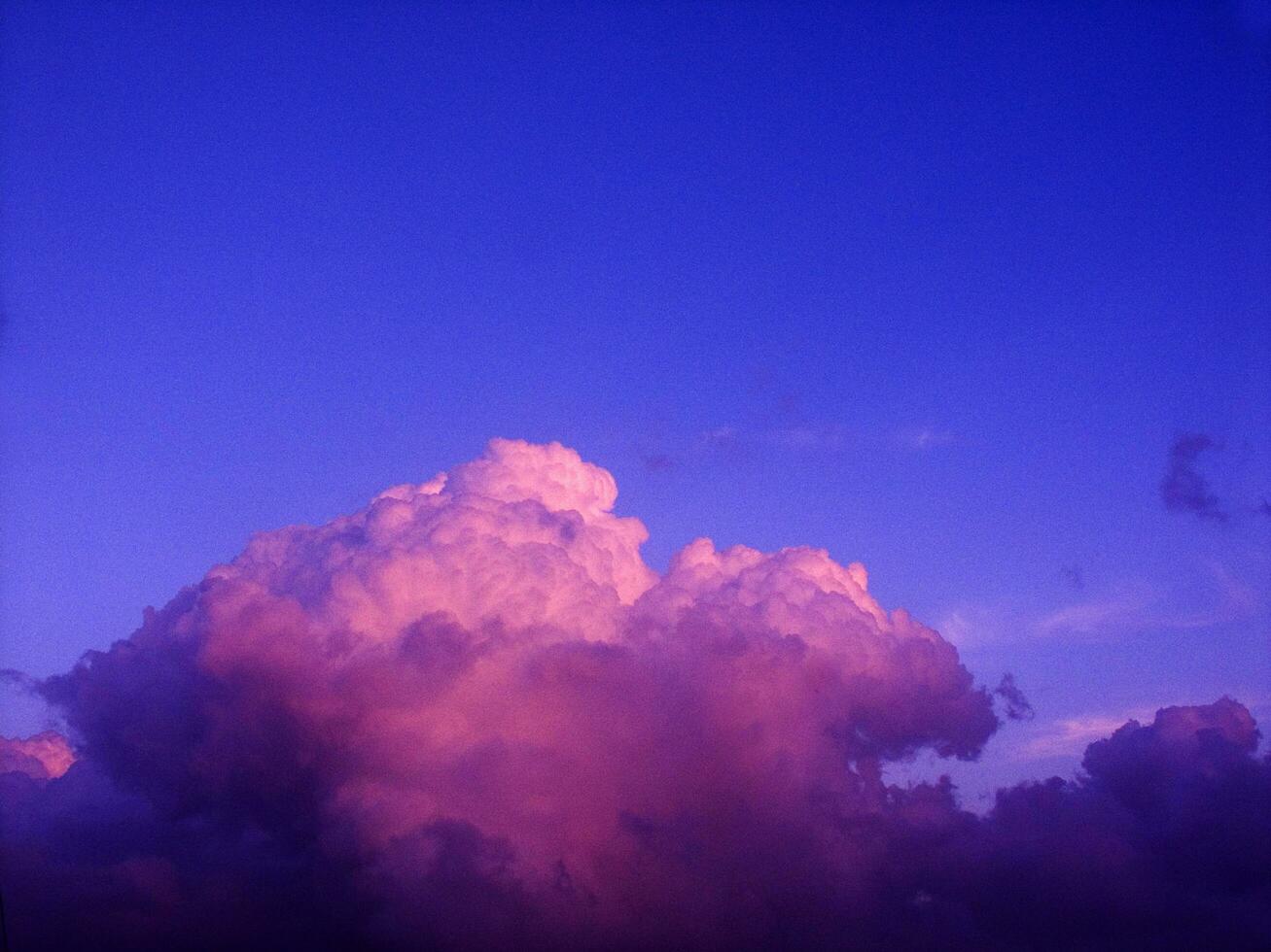 a jet plane flying through a cloudy sky photo