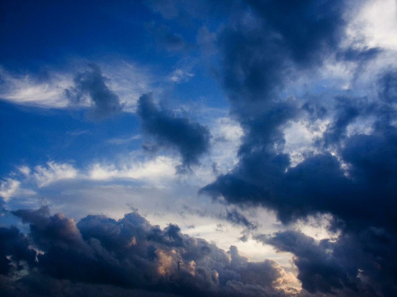 a jet plane flying through a cloudy sky photo