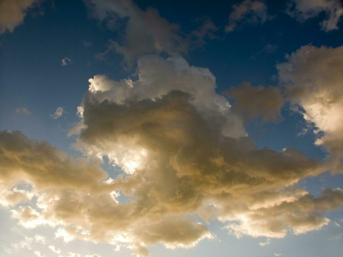 a jet plane flying through a cloudy sky photo