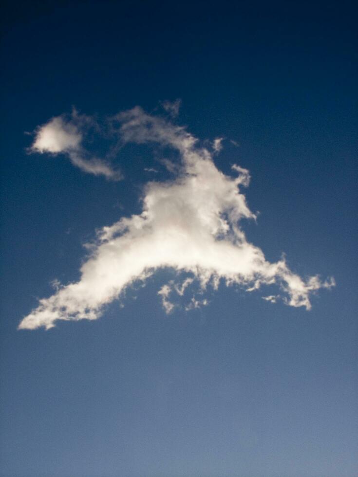 a jet plane flying through a cloudy sky photo