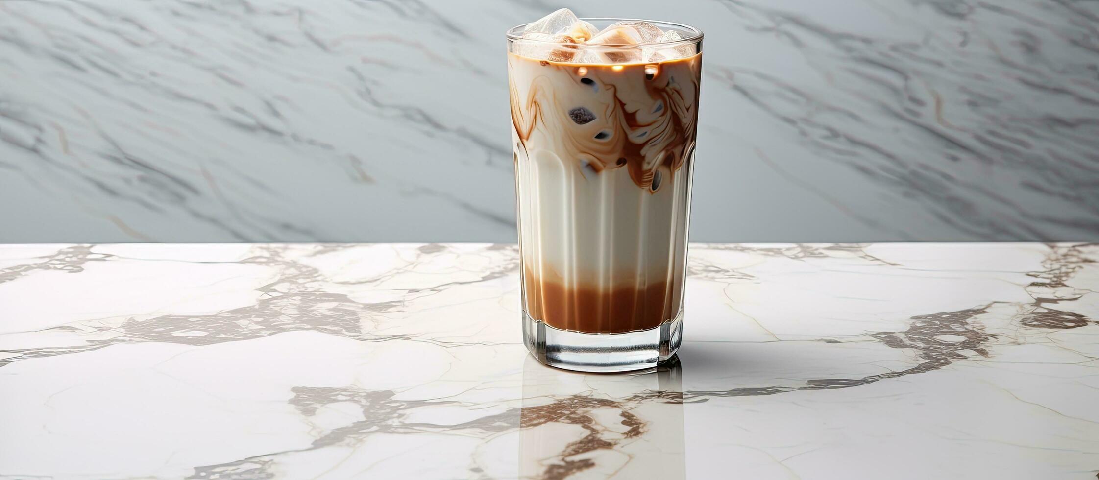 Place a glass filled with milk and iced cocoa on a clear marble surface, leaving space for you photo