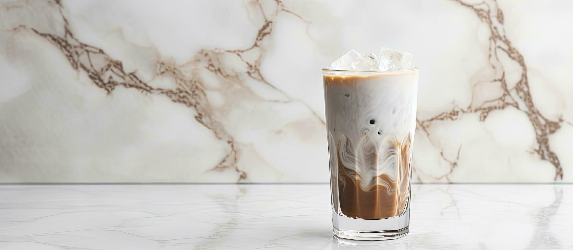 Place a glass filled with milk and iced cocoa on a clear marble surface, leaving space for you photo