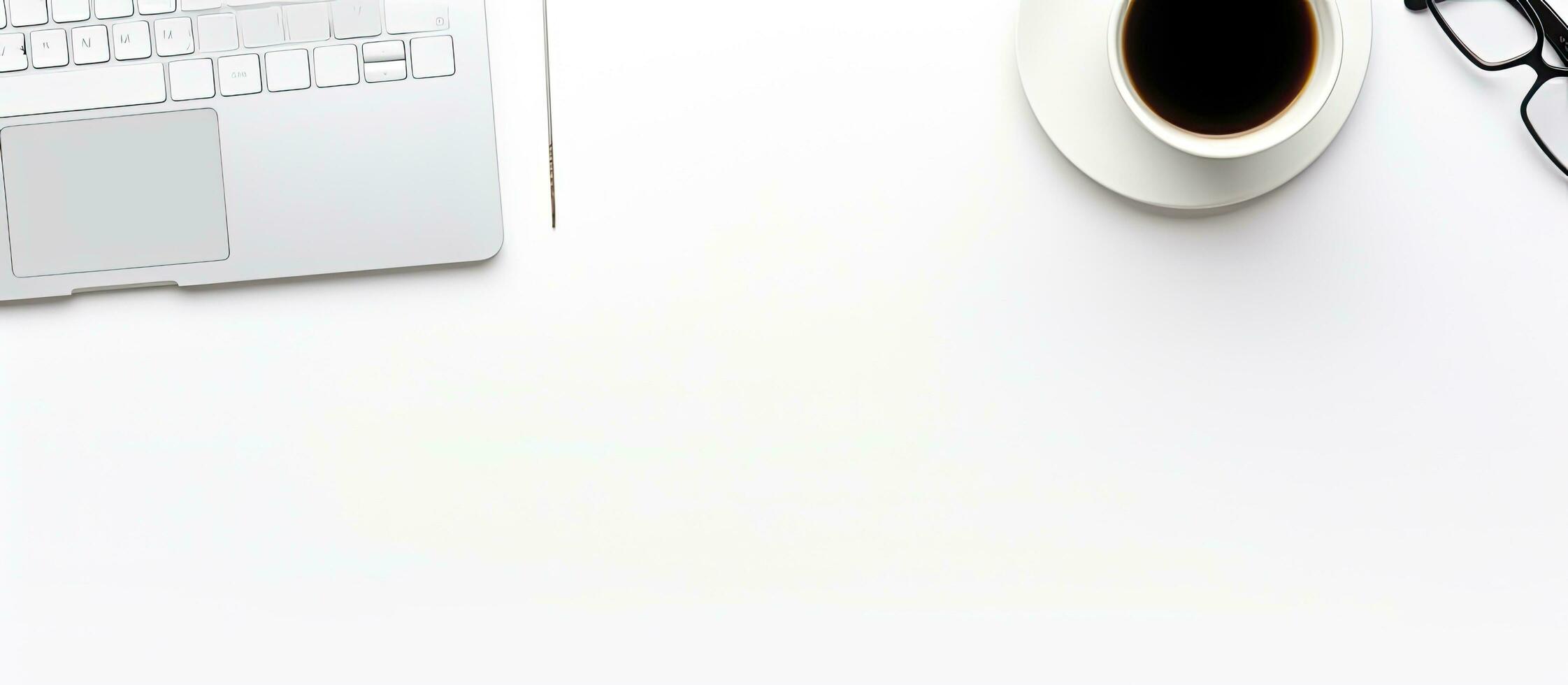 A top view of a white office desk with a notebook, keyboard, pencil holder, and a cup of coffee. photo