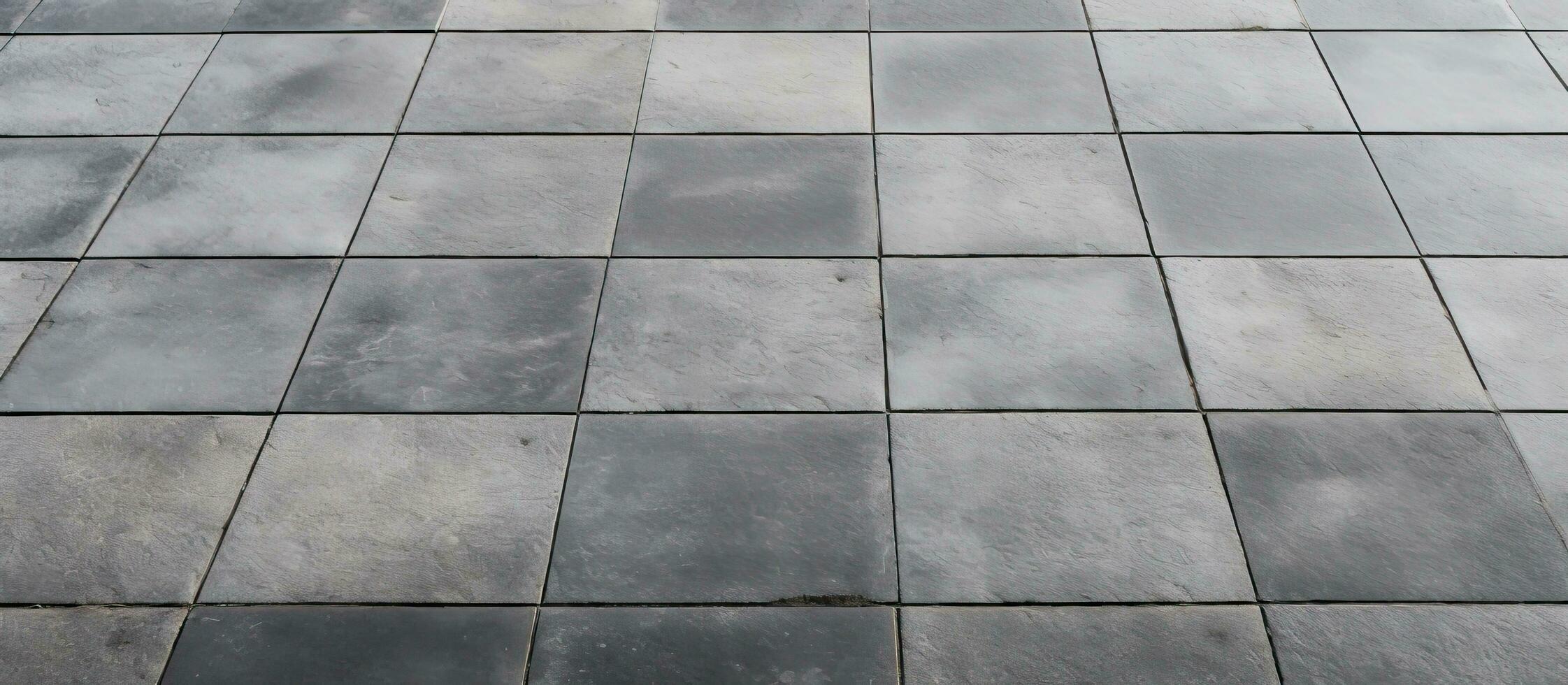 Rows and lines of square sidewalk tiles in a gray color are found on floors either outside or photo