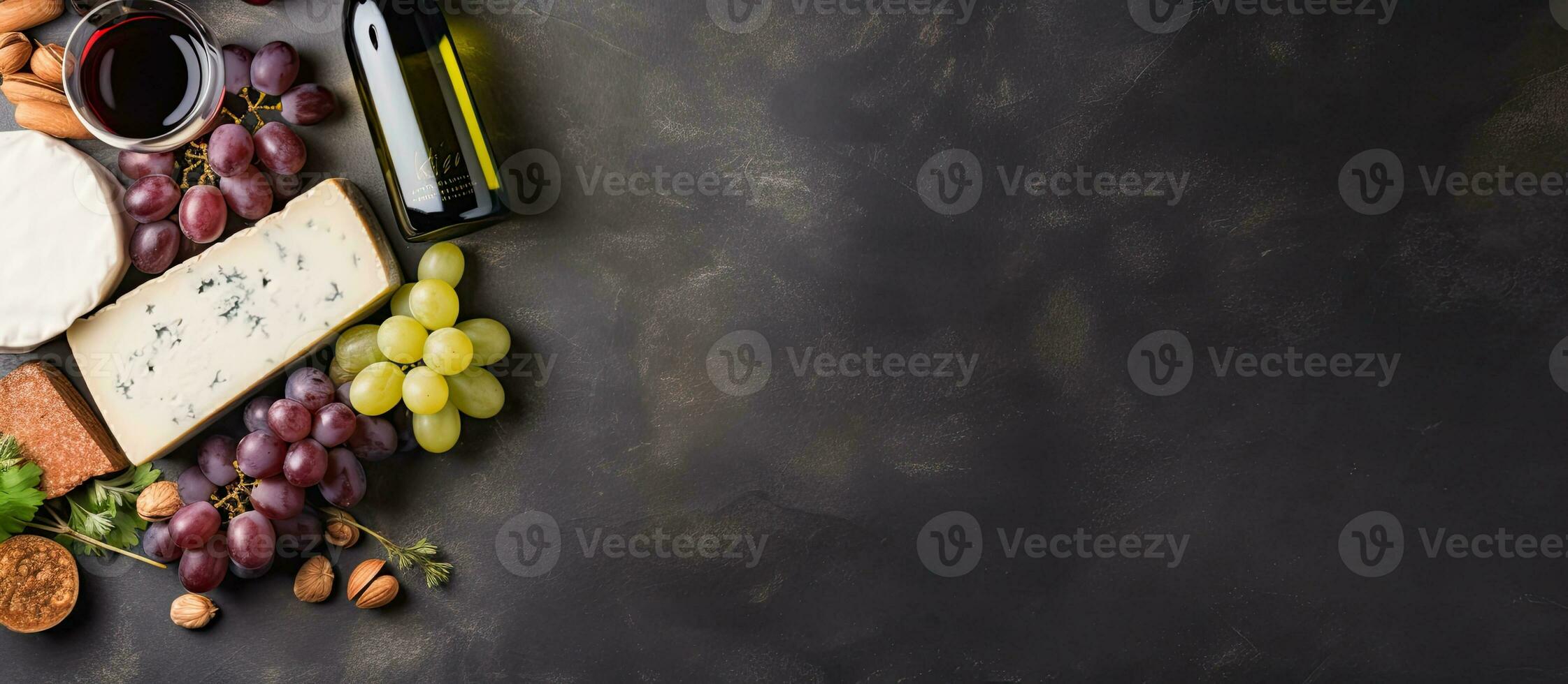 Red And White Wine Bottles, Grape, Cheese And Sausages Over Stone Table. Top View With Copy photo