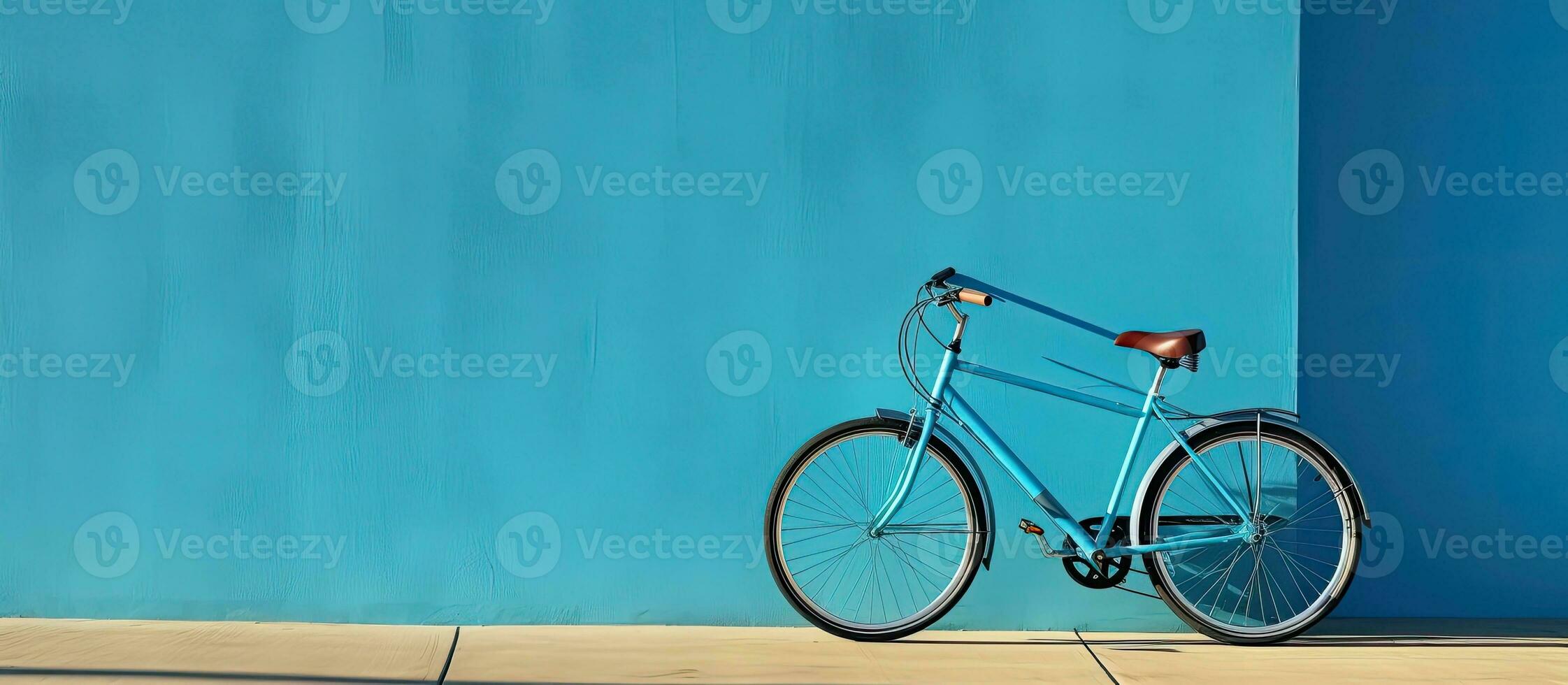 A high-quality photo of a bicycle is positioned against a blue wall, with empty space available