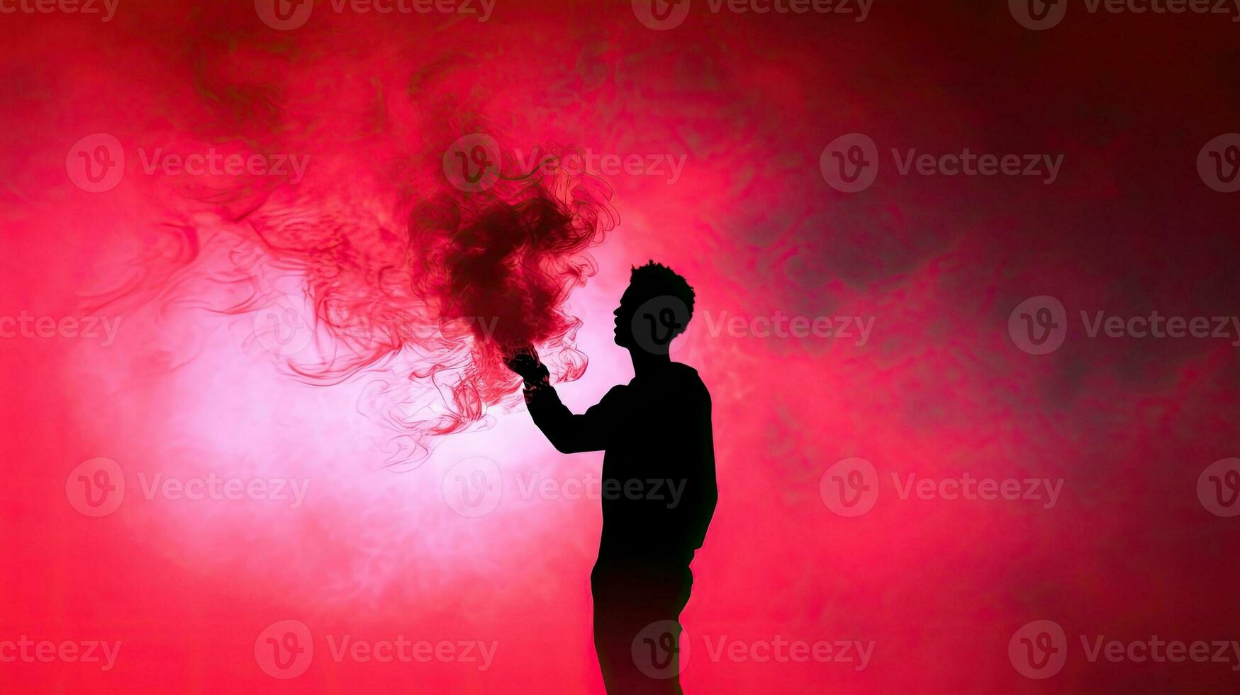 A man with a red smoke stick captured in silhouette photo