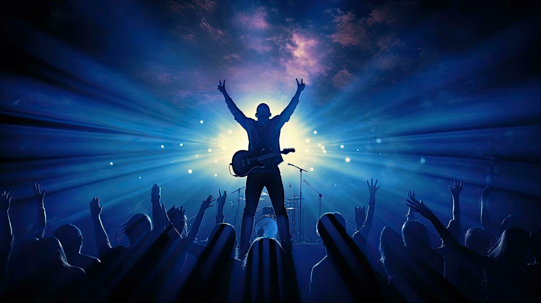 Blue lit silhouette of rock band singer playing guitar and raising hands while singing into microphone photo