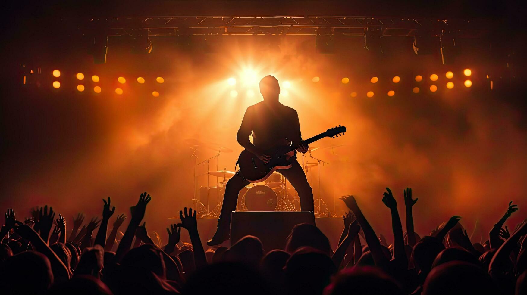 Guitar player performing on stage with crowd in front photo