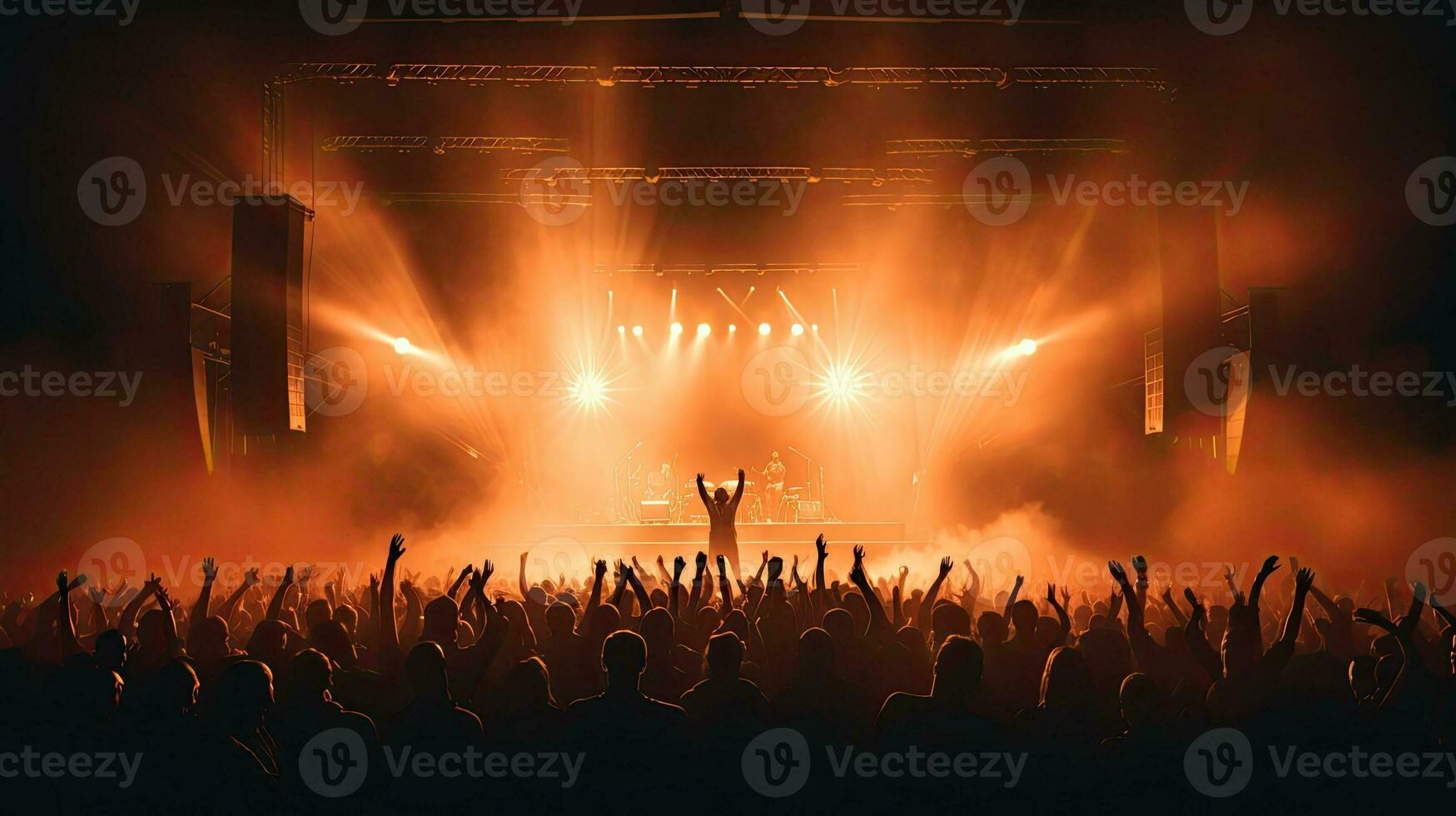 Crowd silhouettes against stage lights photo