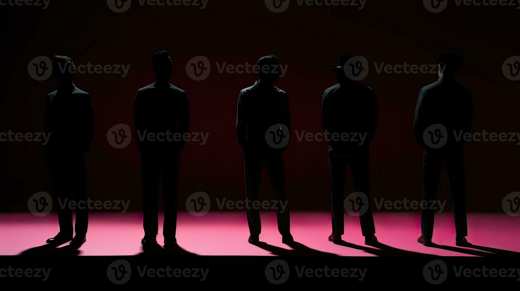 Five paper cutouts of men with one pink man among white ones placed against a black backdrop photo