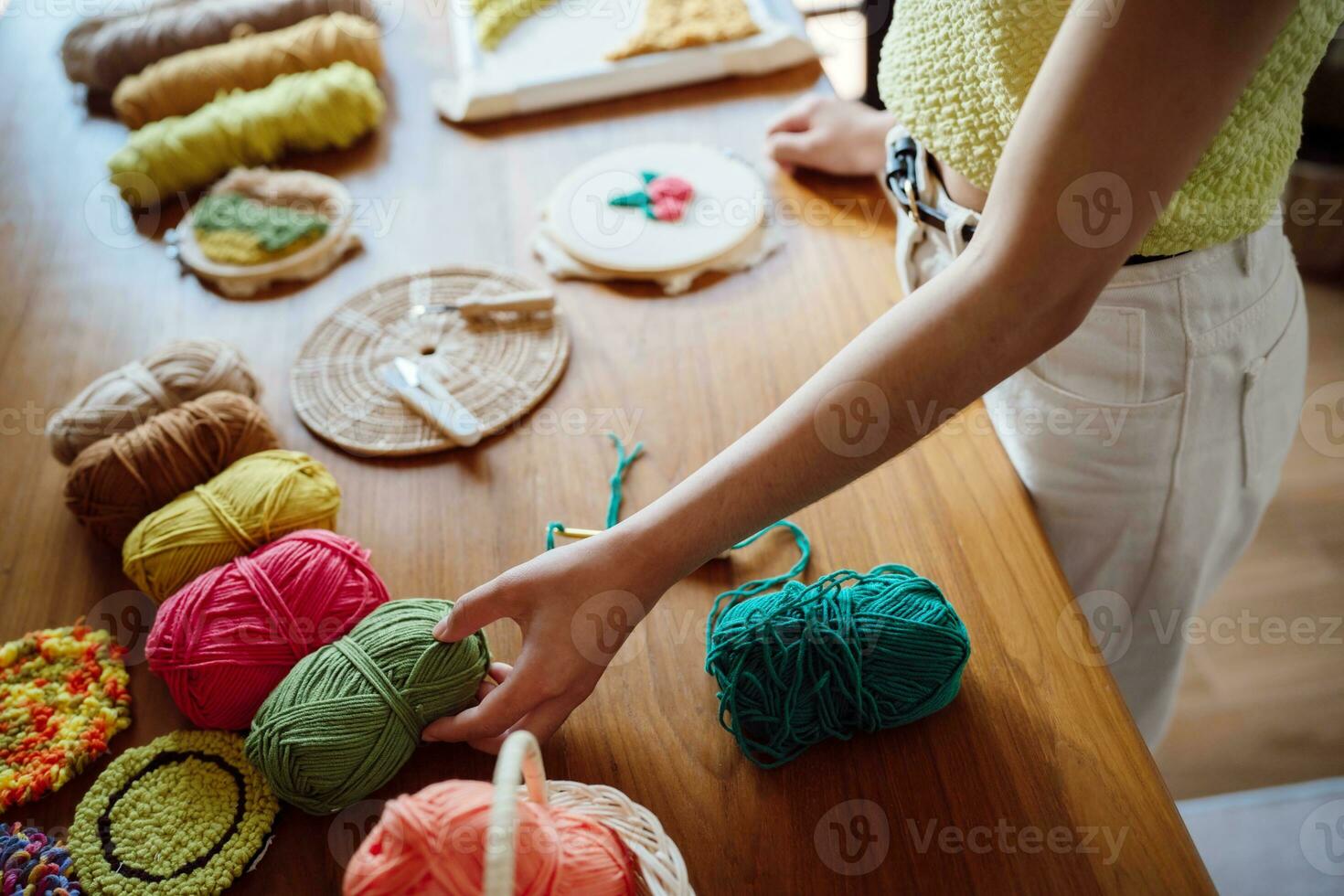 Punch needle. Asian Woman making handmade Hobby knitting in studio workshop. designer workplace Handmade craft project DIY embroidery concept. photo