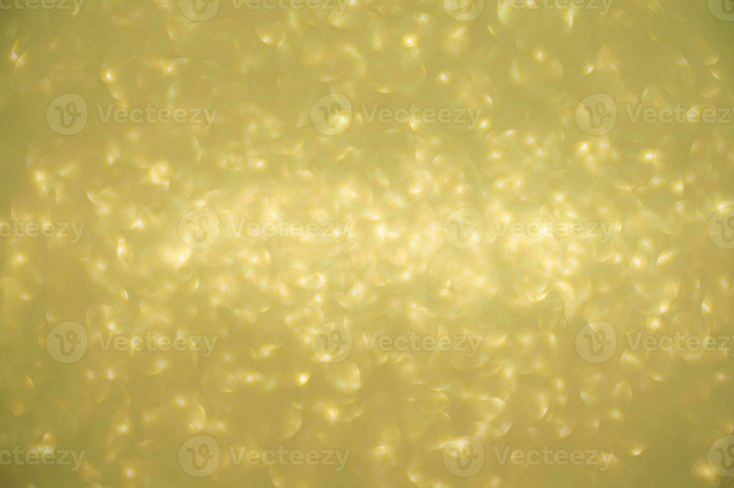 Gold glitters background. shimmering blur spot lights Bokeh Shiny gold light background. photo