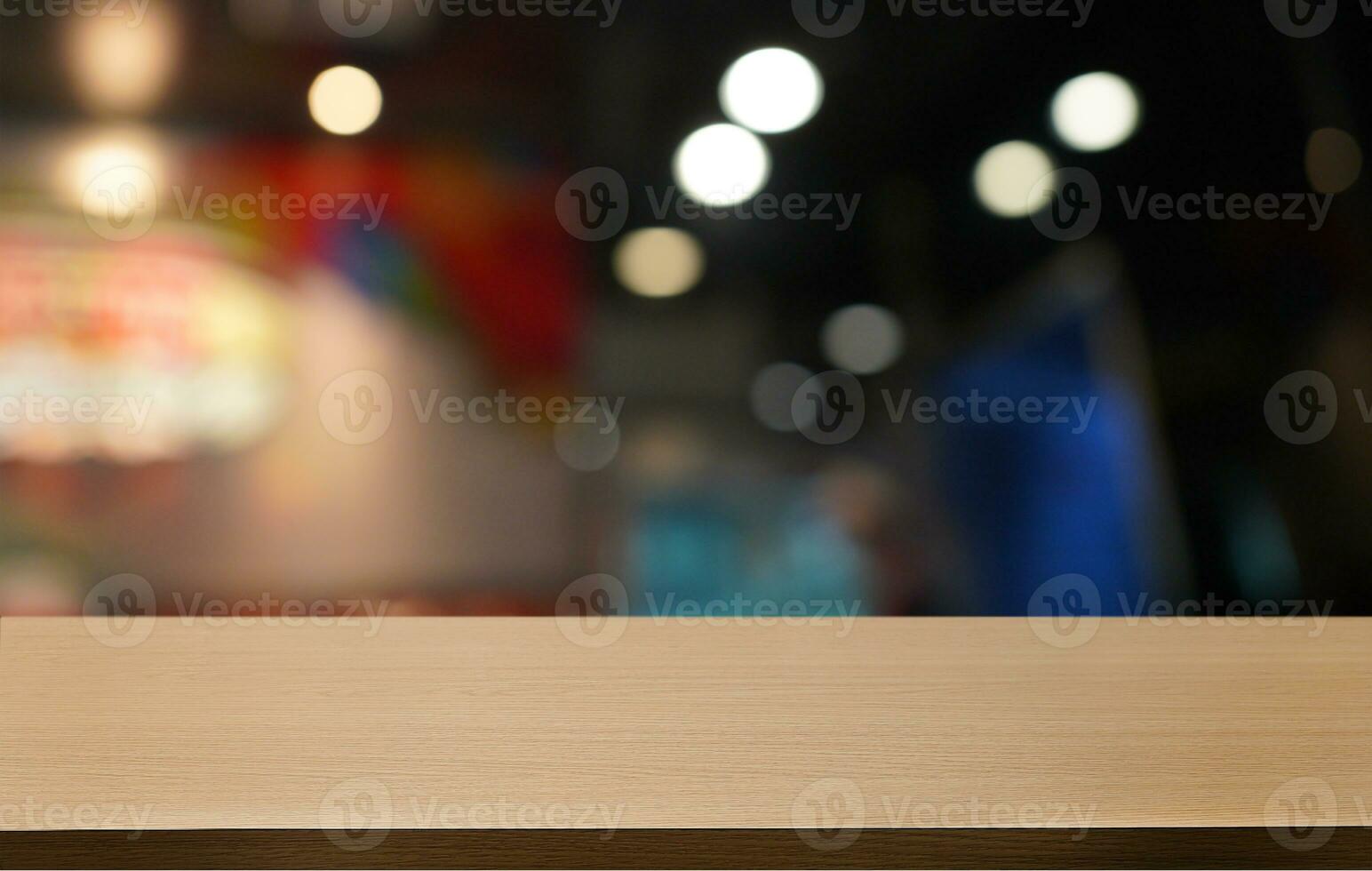Empty wooden table in front of abstract blurred background of coffee shop . can be used for display or montage your products.Mock up for display of product photo