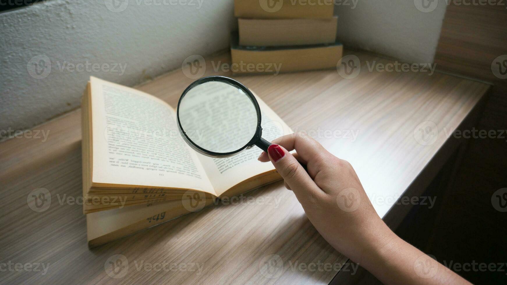 Books and a magnifier Research concept. Magnification glass over a opened book. photo