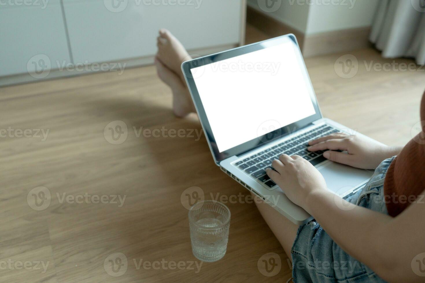 Woman Working by using laptop blank screen computer . Hands typing on a keyboard.technology e-commerce concept. photo