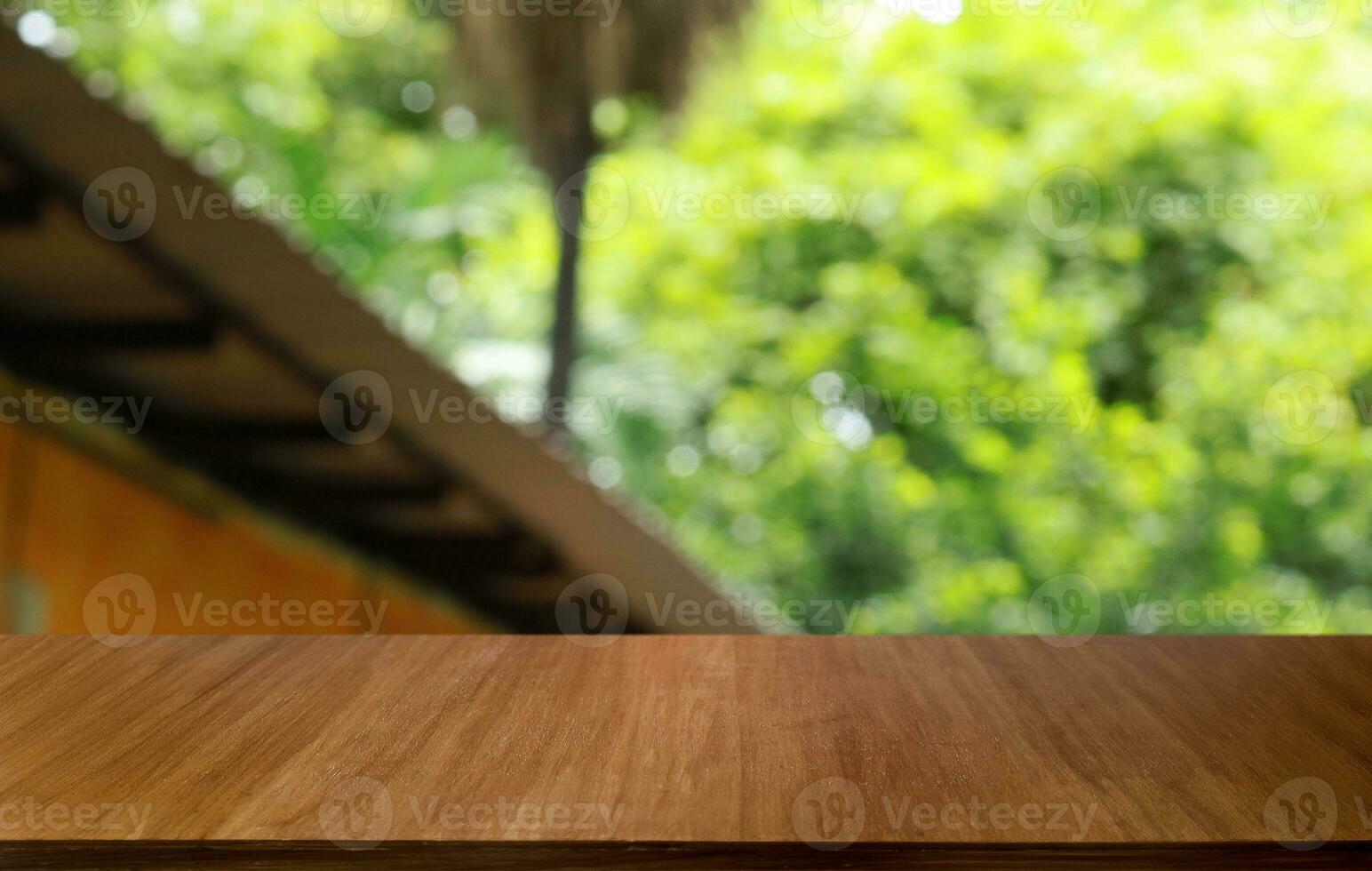 Empty wooden table in front of abstract blurred background of coffee shop . can be used for display or montage your products.Mock up for display of product photo