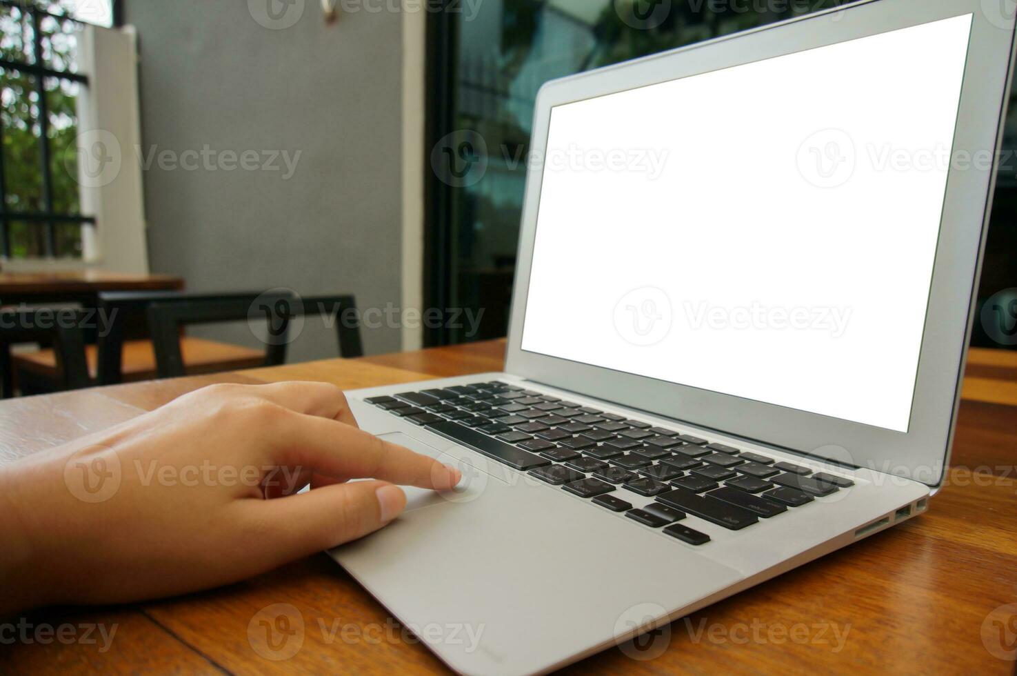 Working by using a laptop computer on wooden table. Hands typing on a keyboard. photo