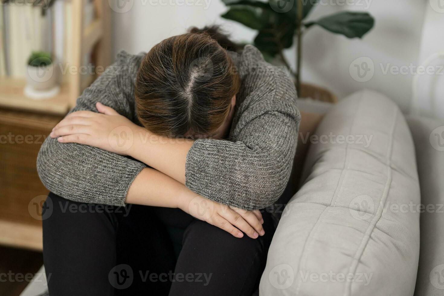 Sad Overweight plus size woman thinking about problems on sofa upset girl feeling lonely and sad from bad relationship or Depressed woman disorder mental health. photo