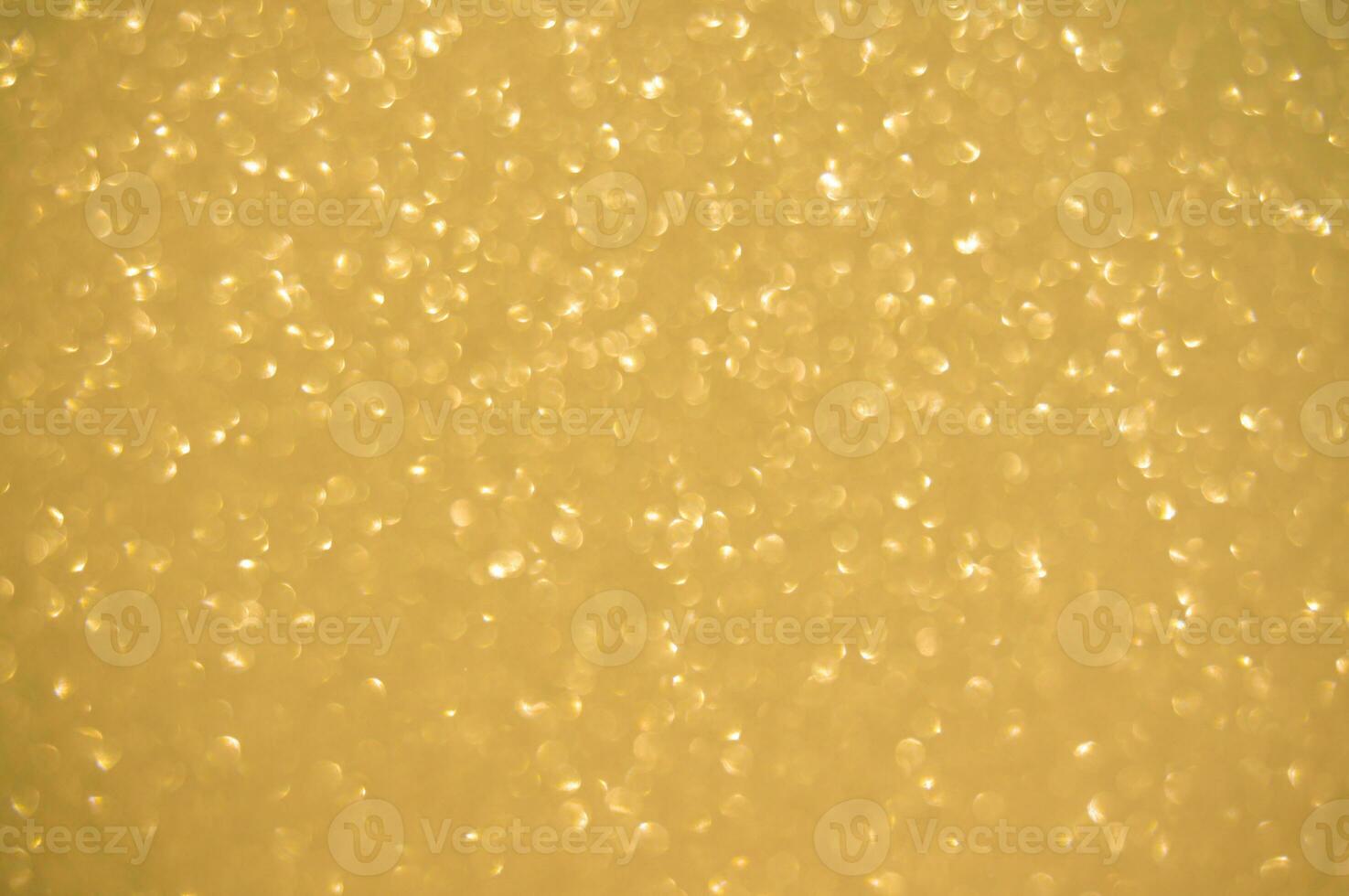 Gold glitters background. shimmering blur spot lights Bokeh Shiny gold light background. photo