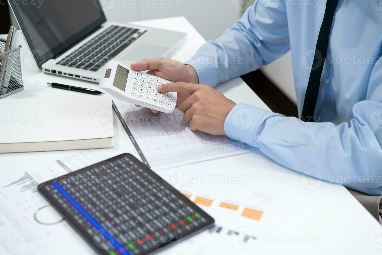 Saving money. Businessman Accountant verify growing business and saving money stacking coins with calculator. Accountancy Concept. photo