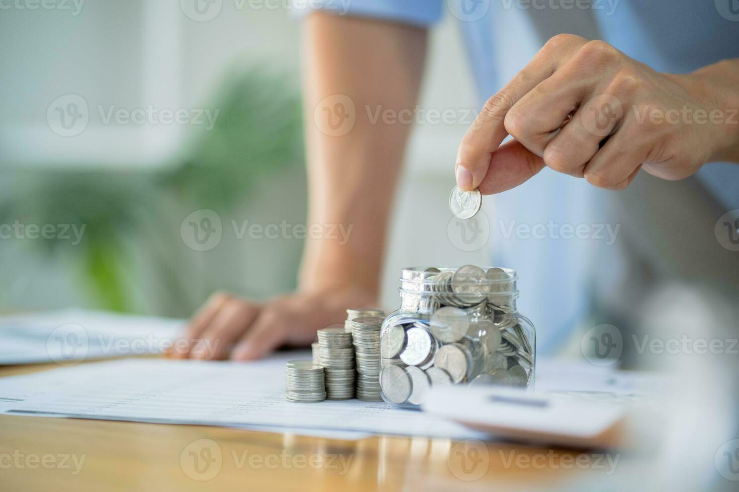 Saving money. Businessman Accountant verify growing business and saving money stacking coins with calculator. Accountancy Concept. photo