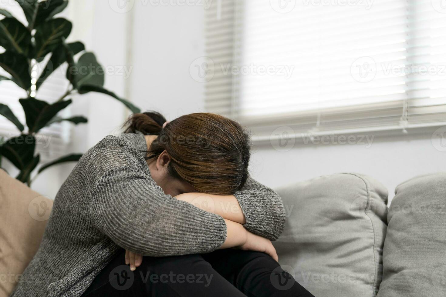 Sad Overweight plus size woman thinking about problems on sofa upset girl feeling lonely and sad from bad relationship or Depressed woman disorder mental health. photo