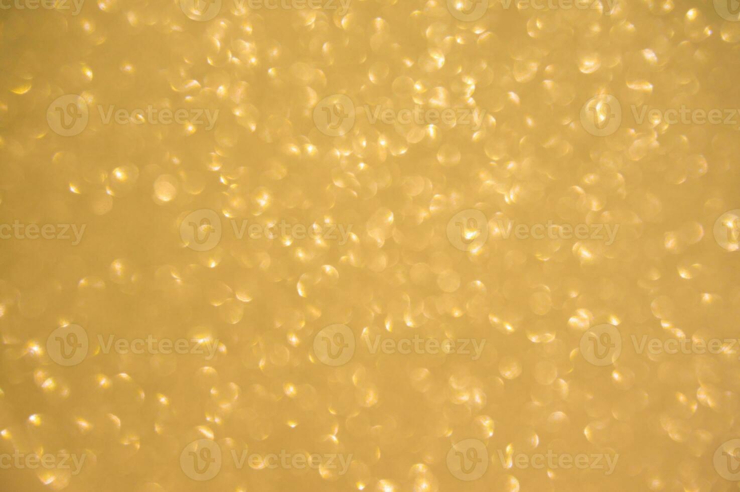 Gold glitters background. shimmering blur spot lights Bokeh Shiny gold light background. photo