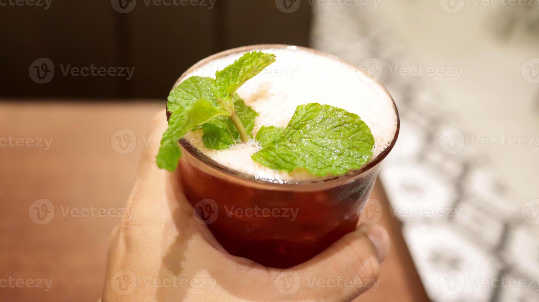 Ice lychee tea with mint leaf served at the table is a tea with delightful sweet, mellow, smooth taste with very pleasant lychee aroma. photo