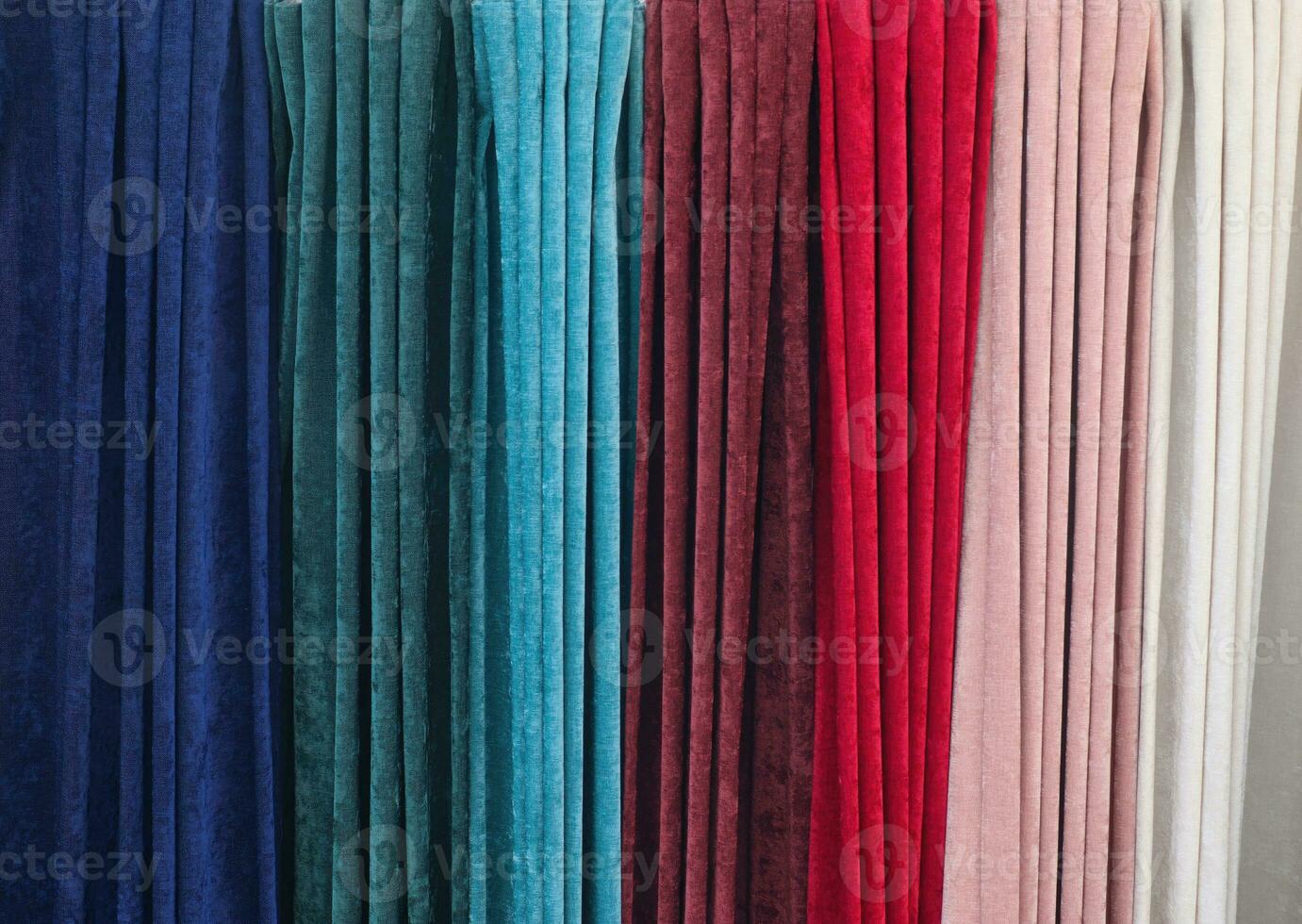 Detailed close up view on samples of cloth and fabrics in different colors found at a fabrics market photo